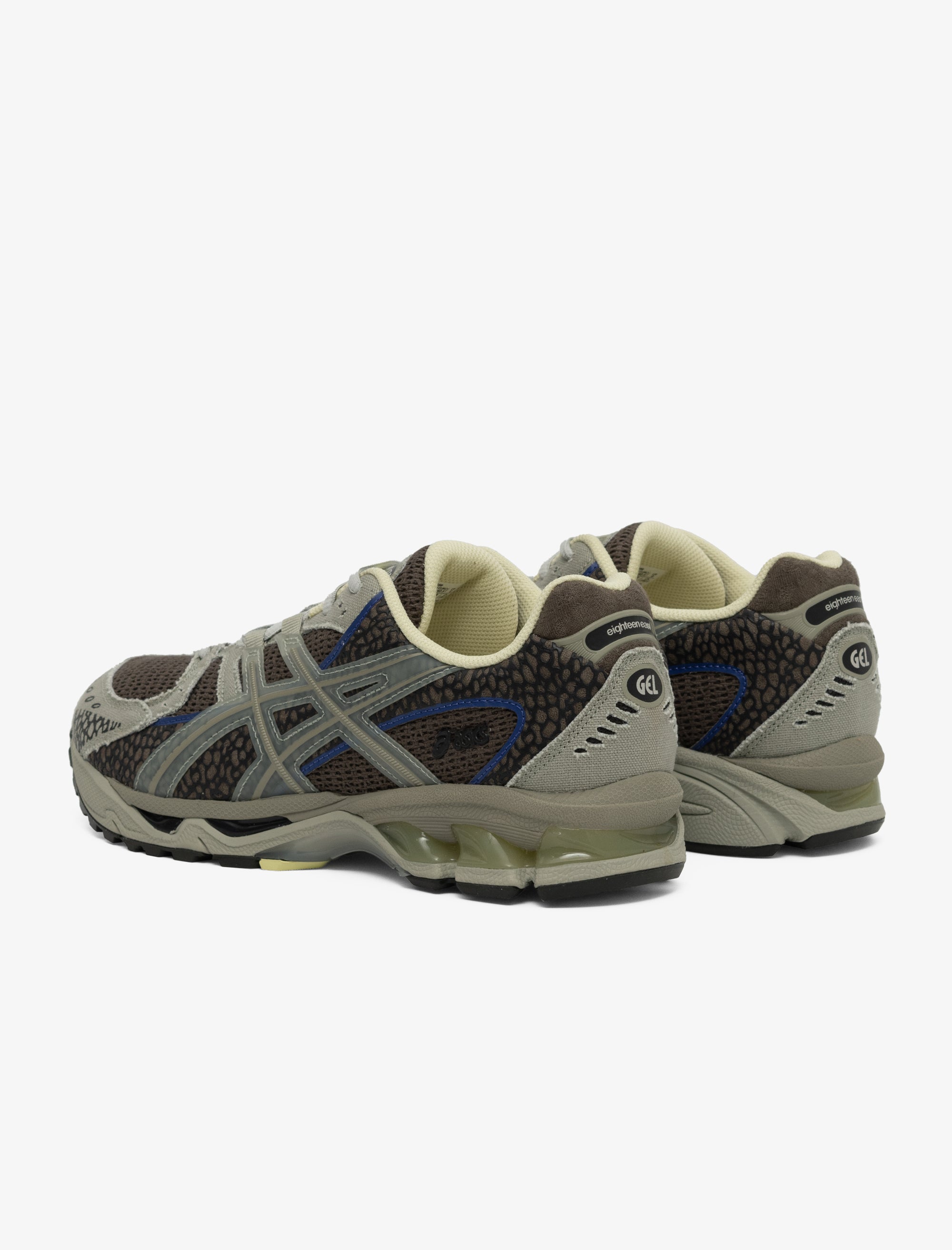 Pair of gray and brown athletic shoes on a white background