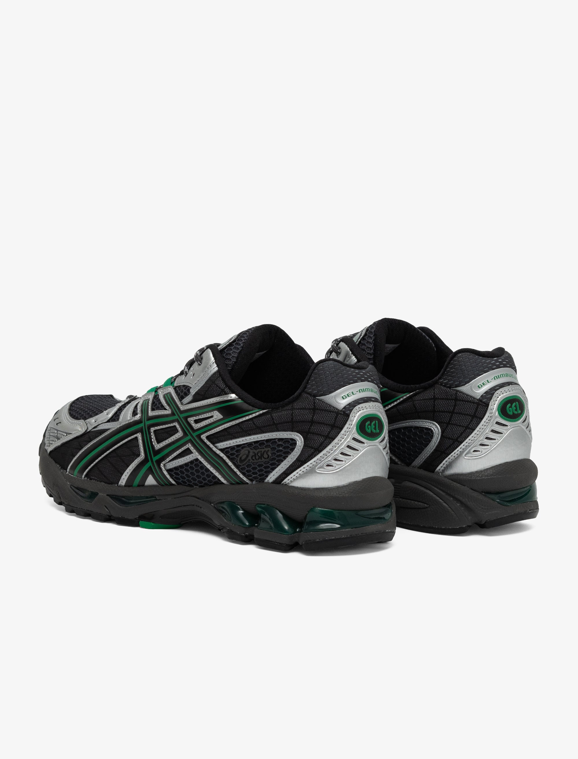 Black, gray, and green running shoes on a white background
