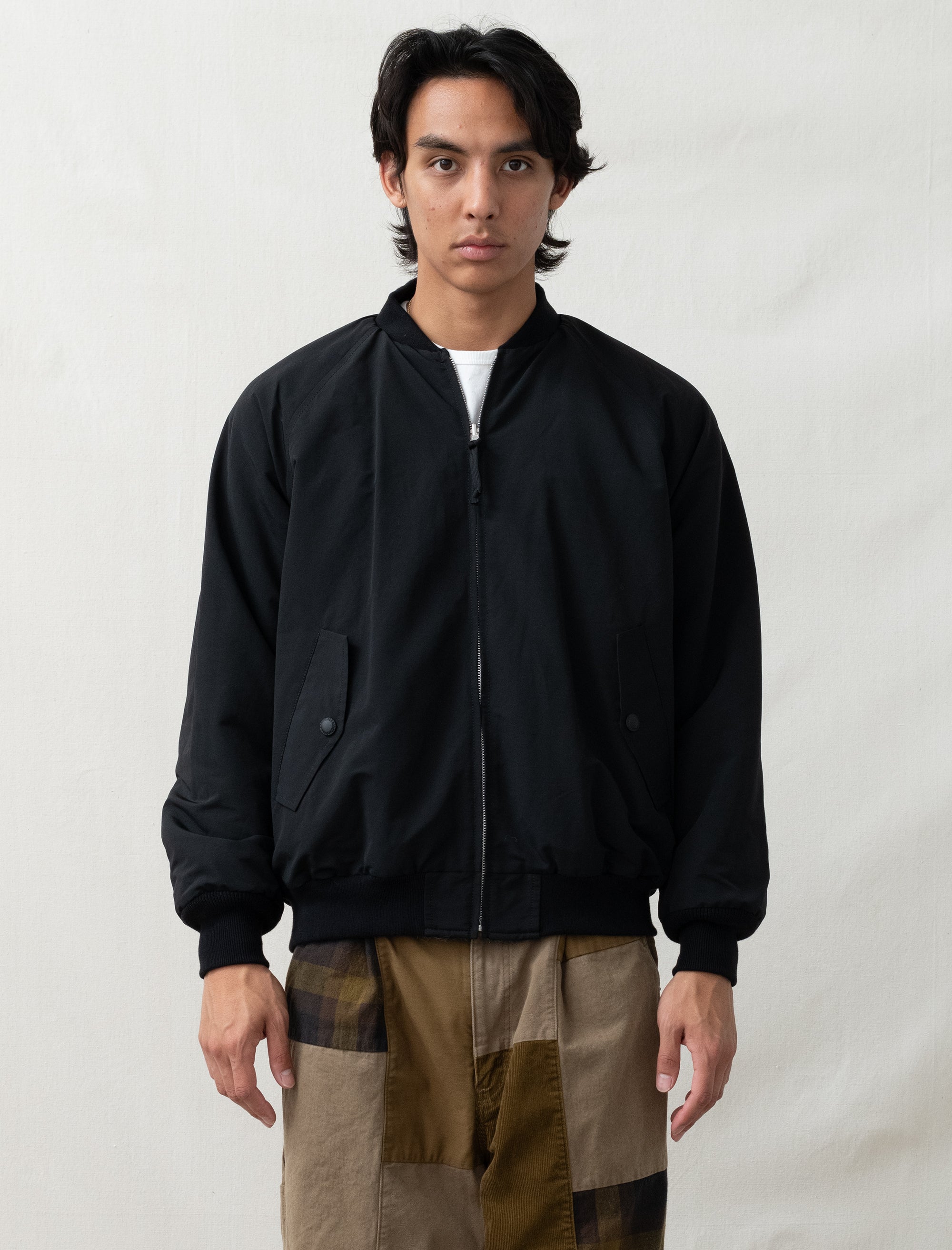 reversible comme bomber in front of white back ground