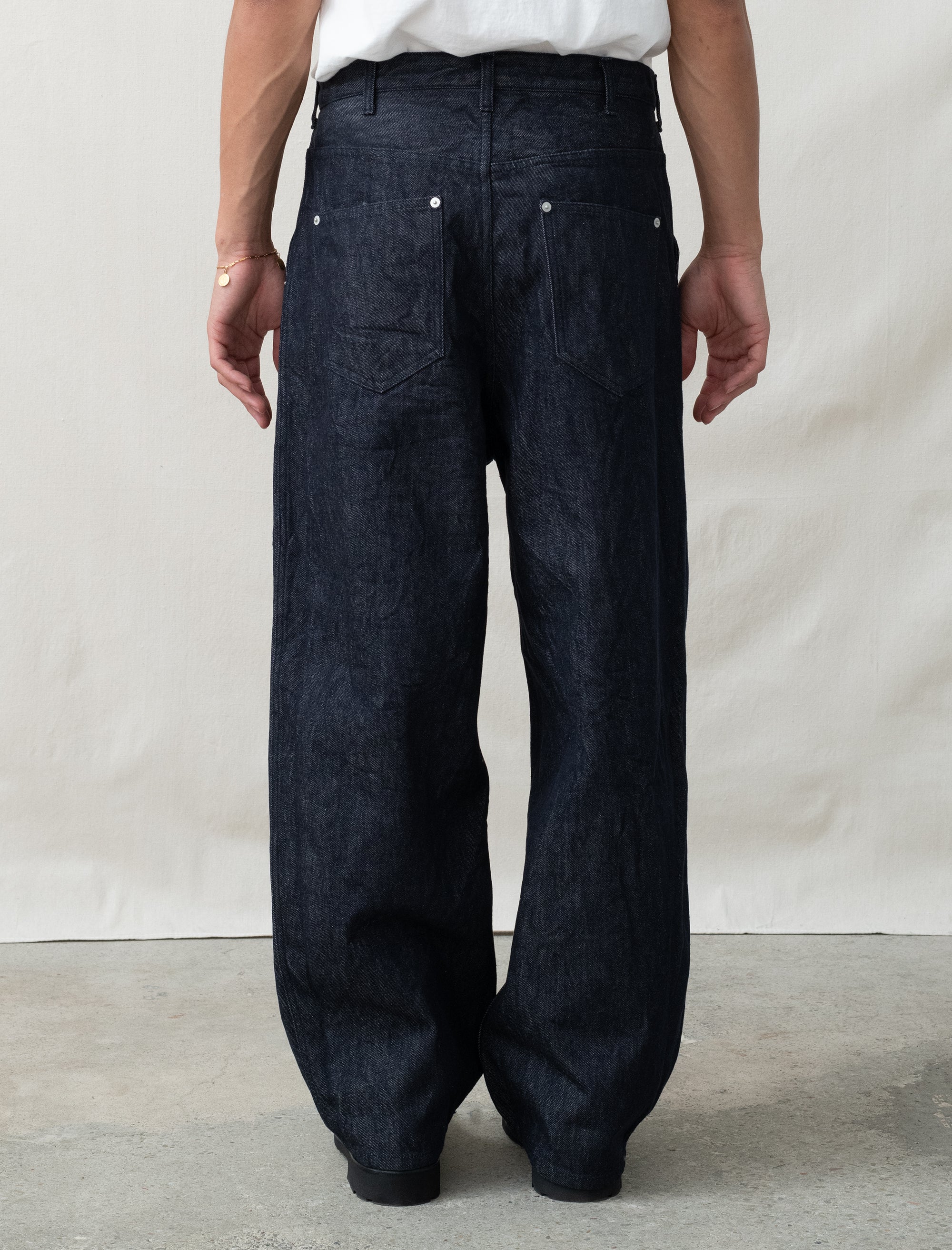 person wearing jeans in front of white background