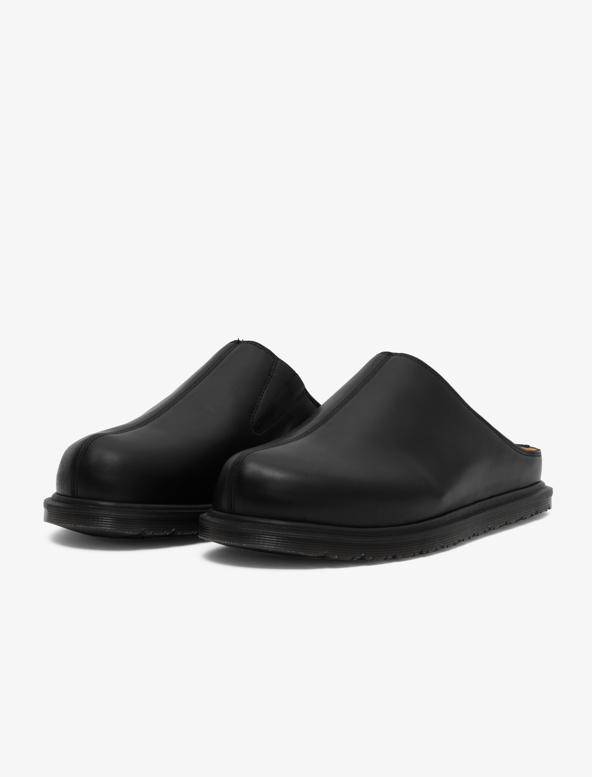 Pair of black slip-on shoes on a white background