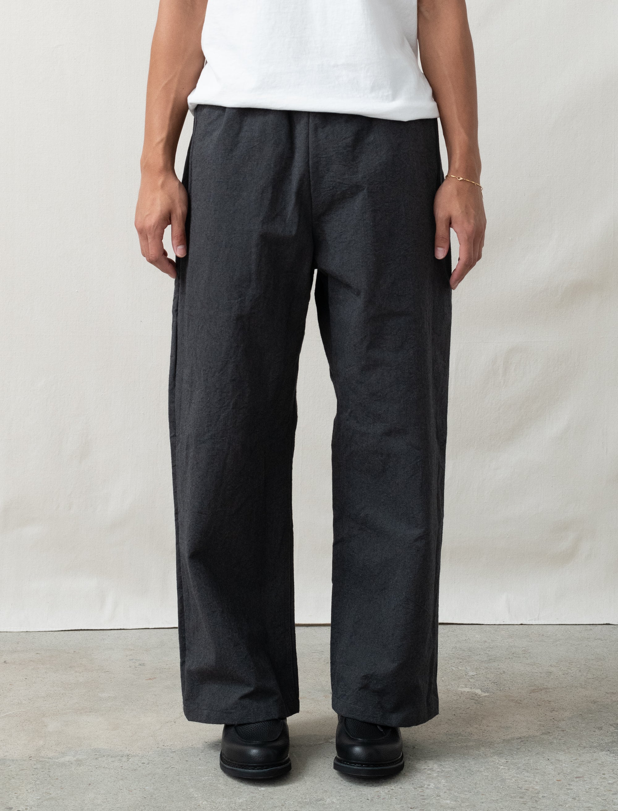 wool pants on person in front of white background