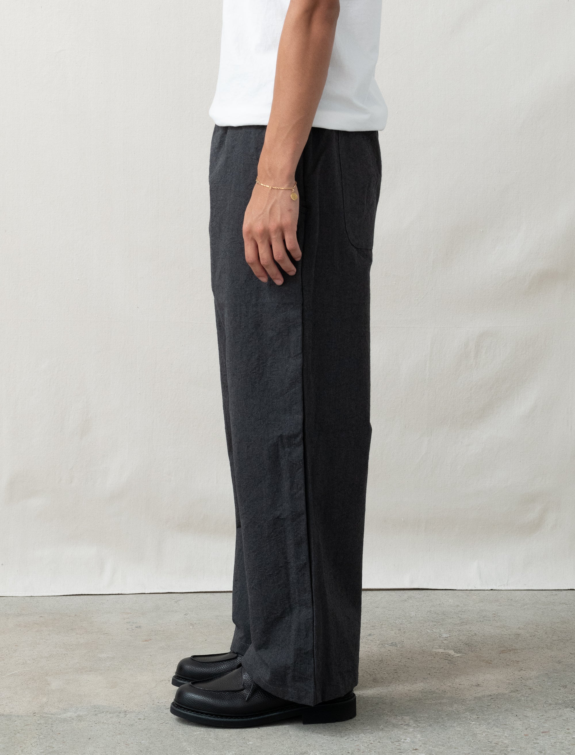 wool pants on person in front of white background