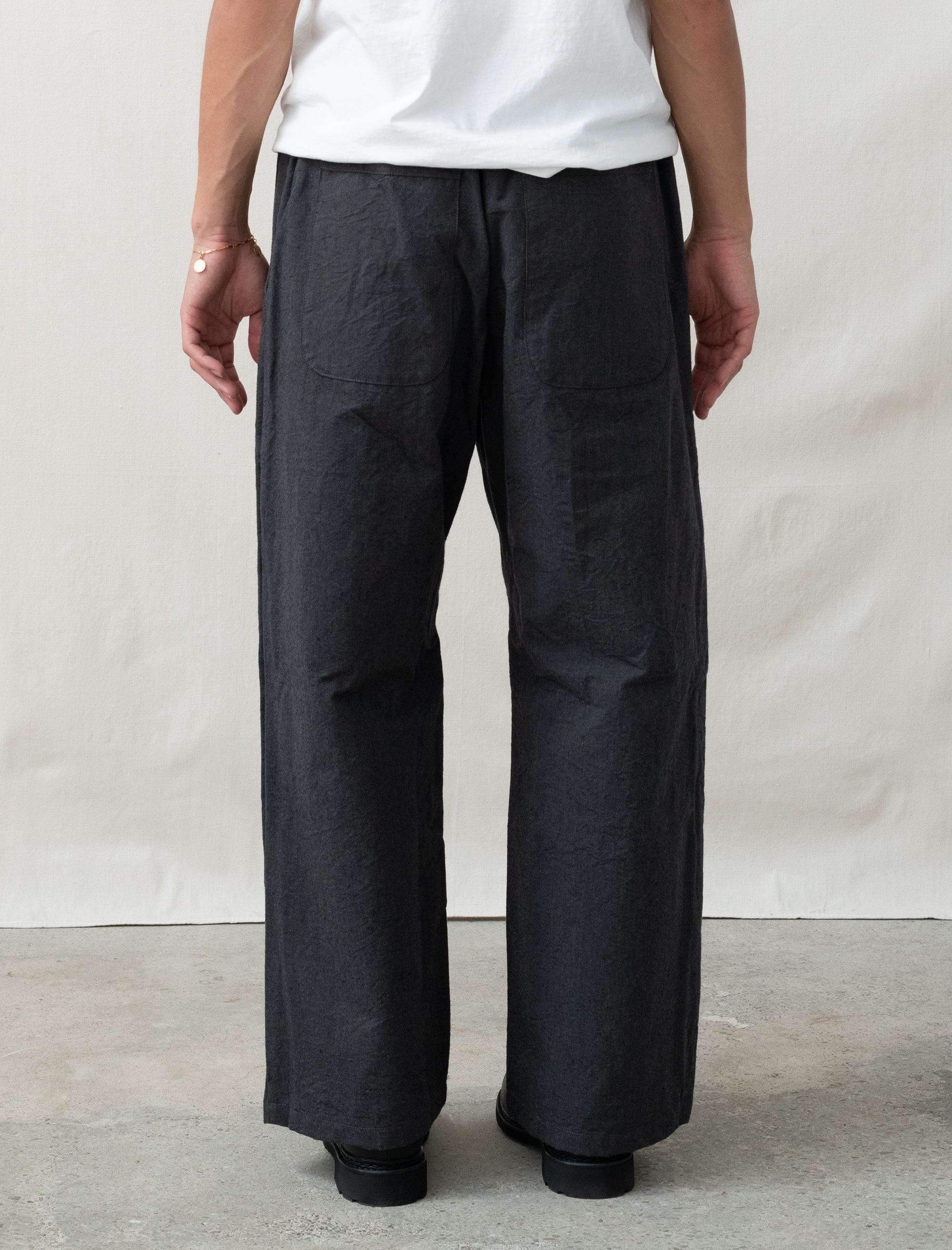 wool pants on person in front of white background