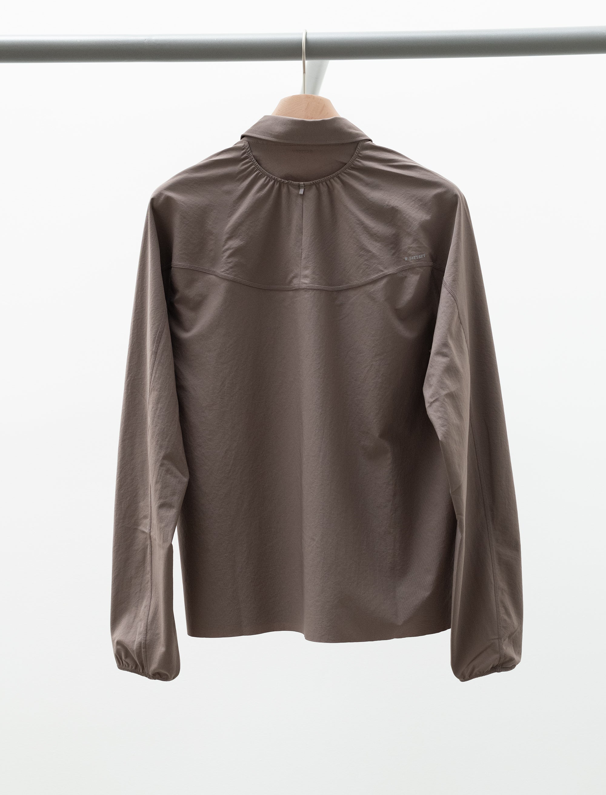 Brown jacket on a hanger against a white background