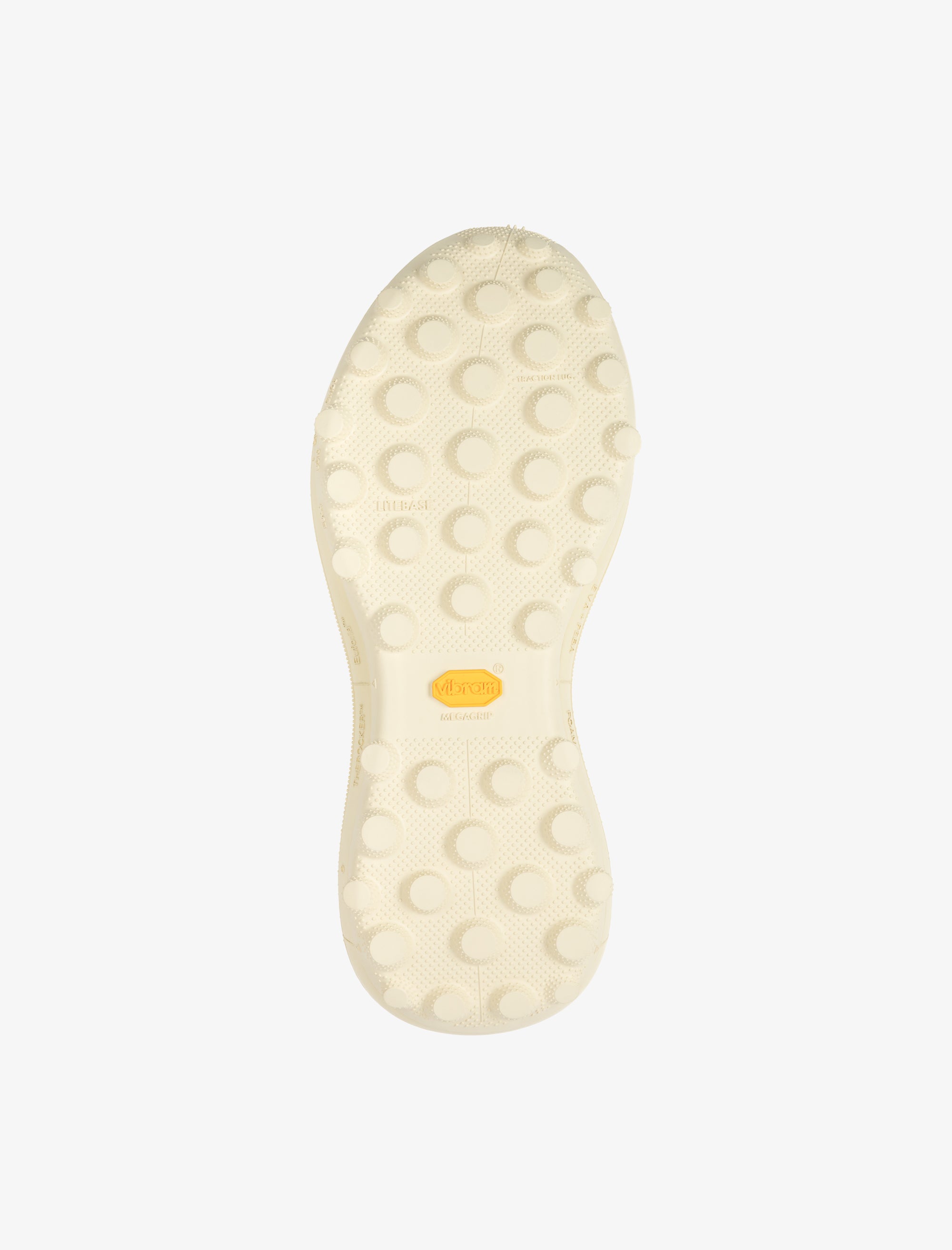 Close-up of a white shoe sole with a yellow label on a light gray background
