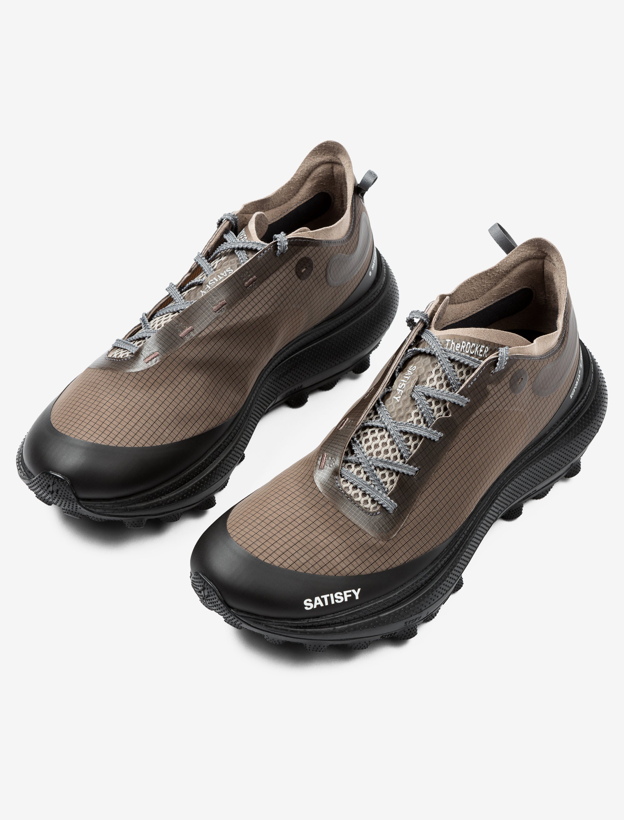 Pair of brown and black shoes with 'Satisfy' branding on a white background