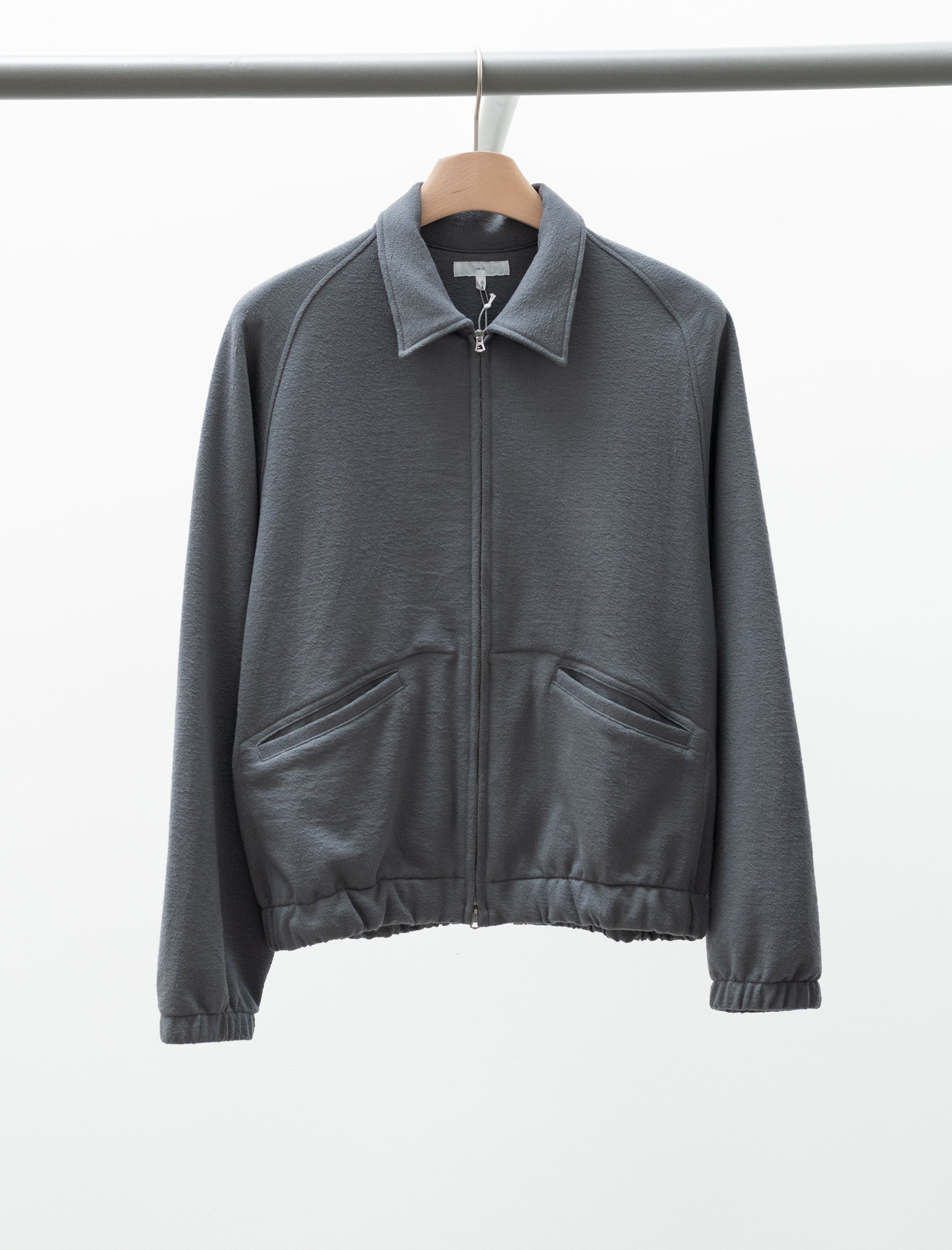 Gray jacket on a hanger against a white background