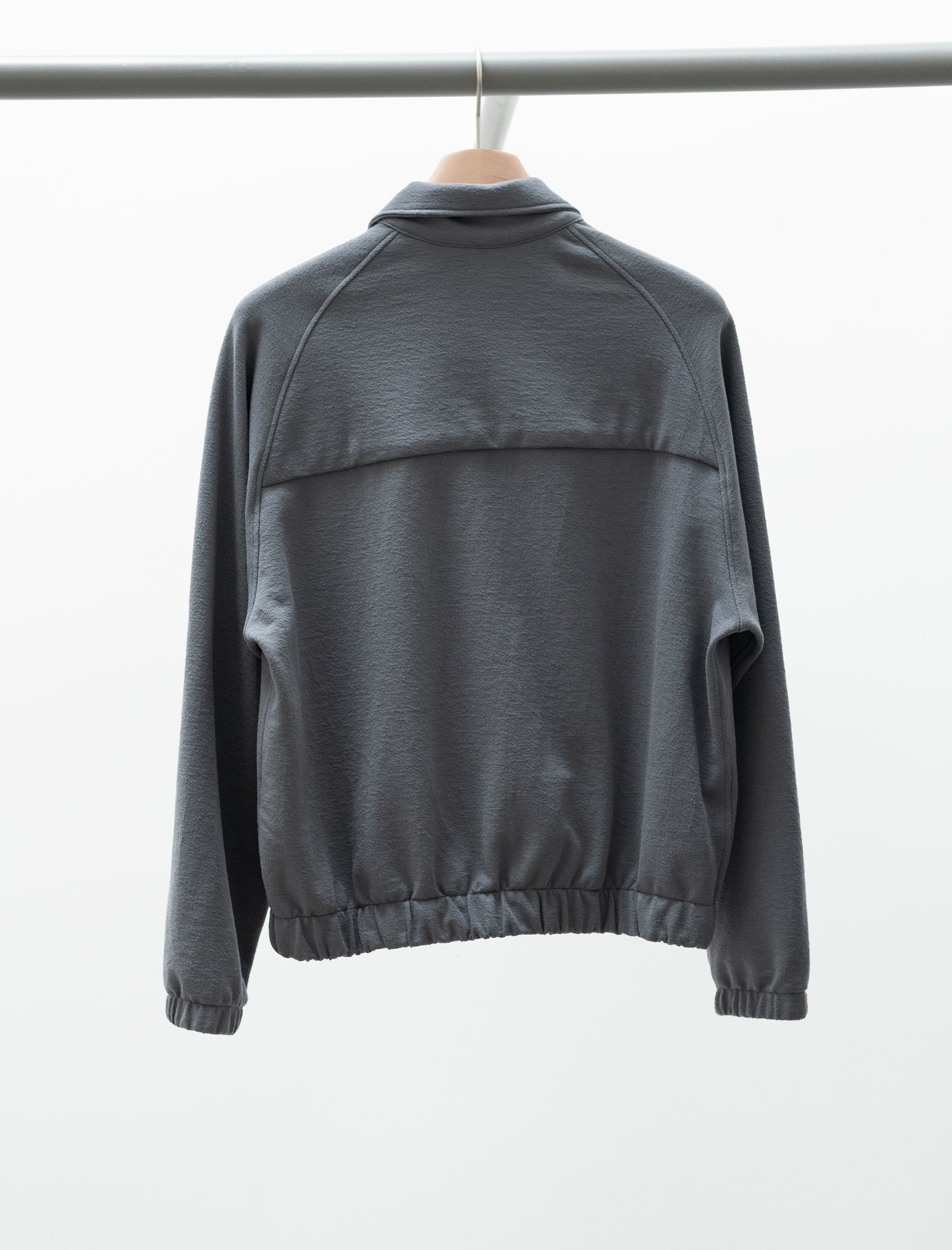 Gray jacket on a hanger against a white background