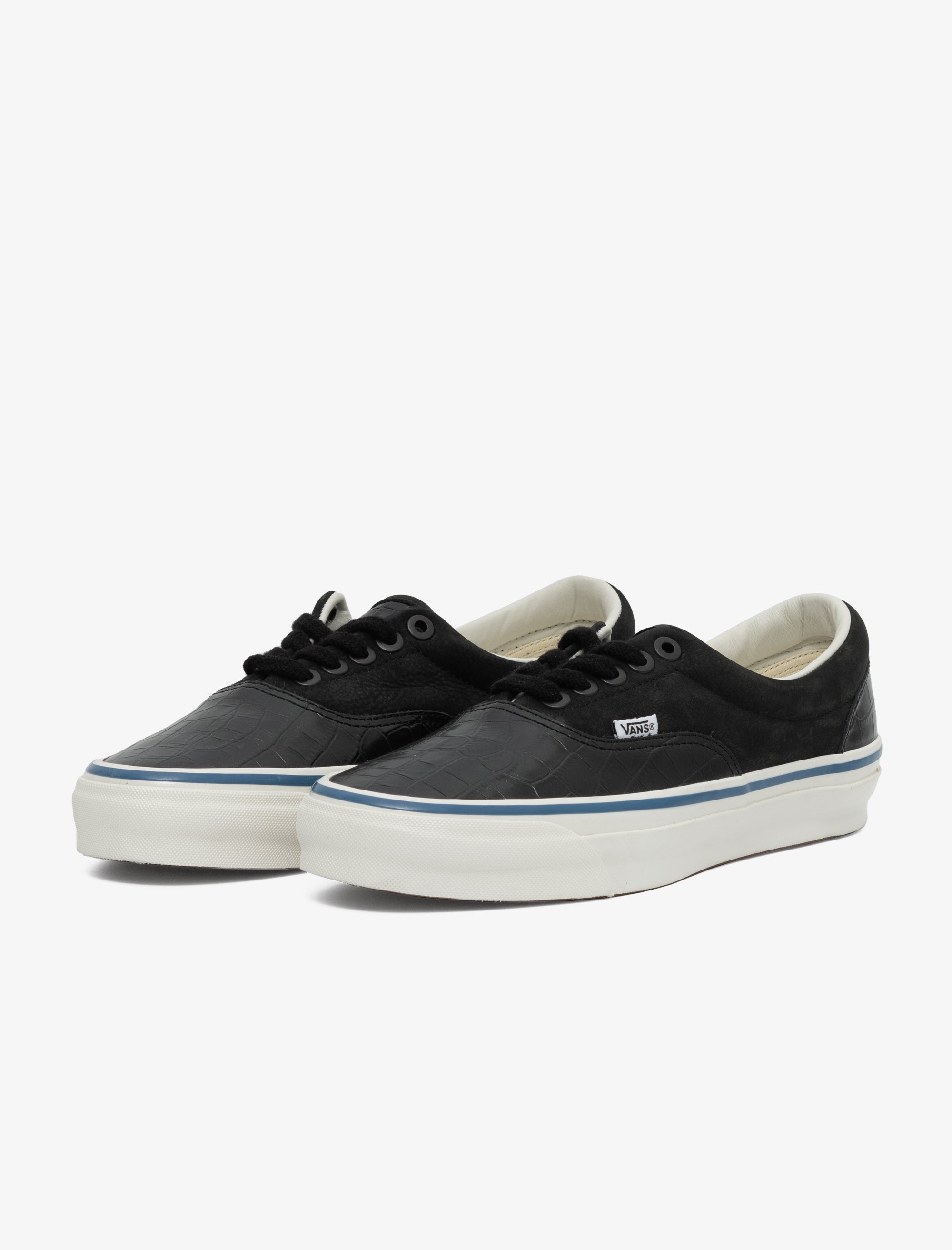 Pair of black sneakers with white soles on a white background