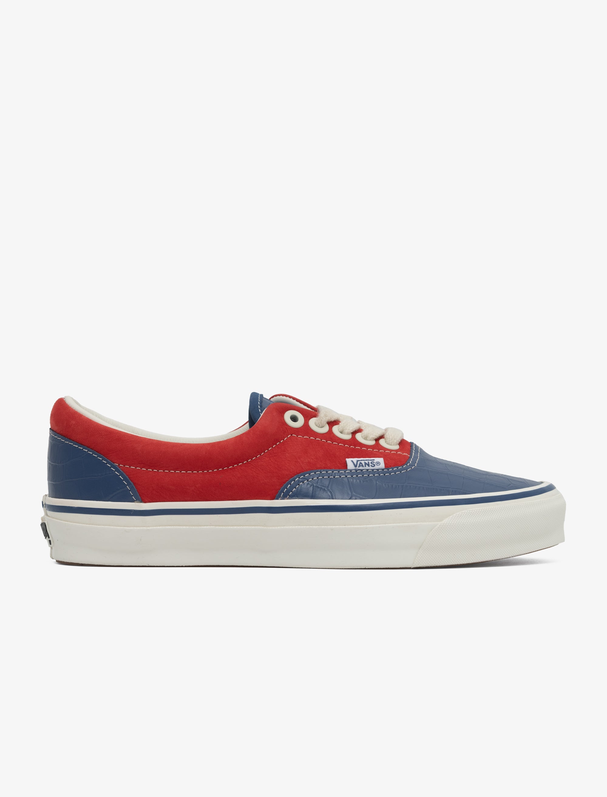 Red and blue sneaker with white sole on a light gray background