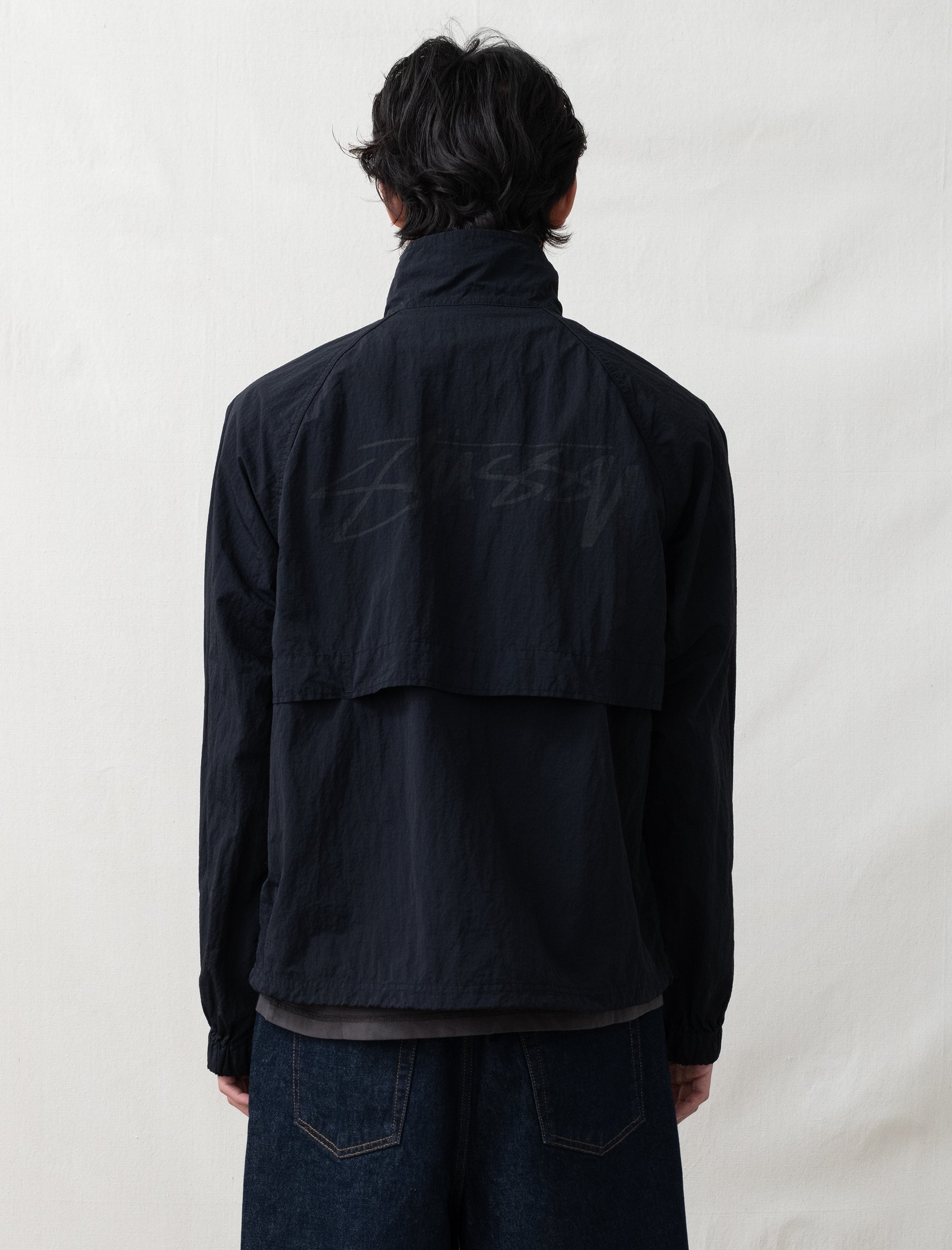 someone wearing a black jacket on white background