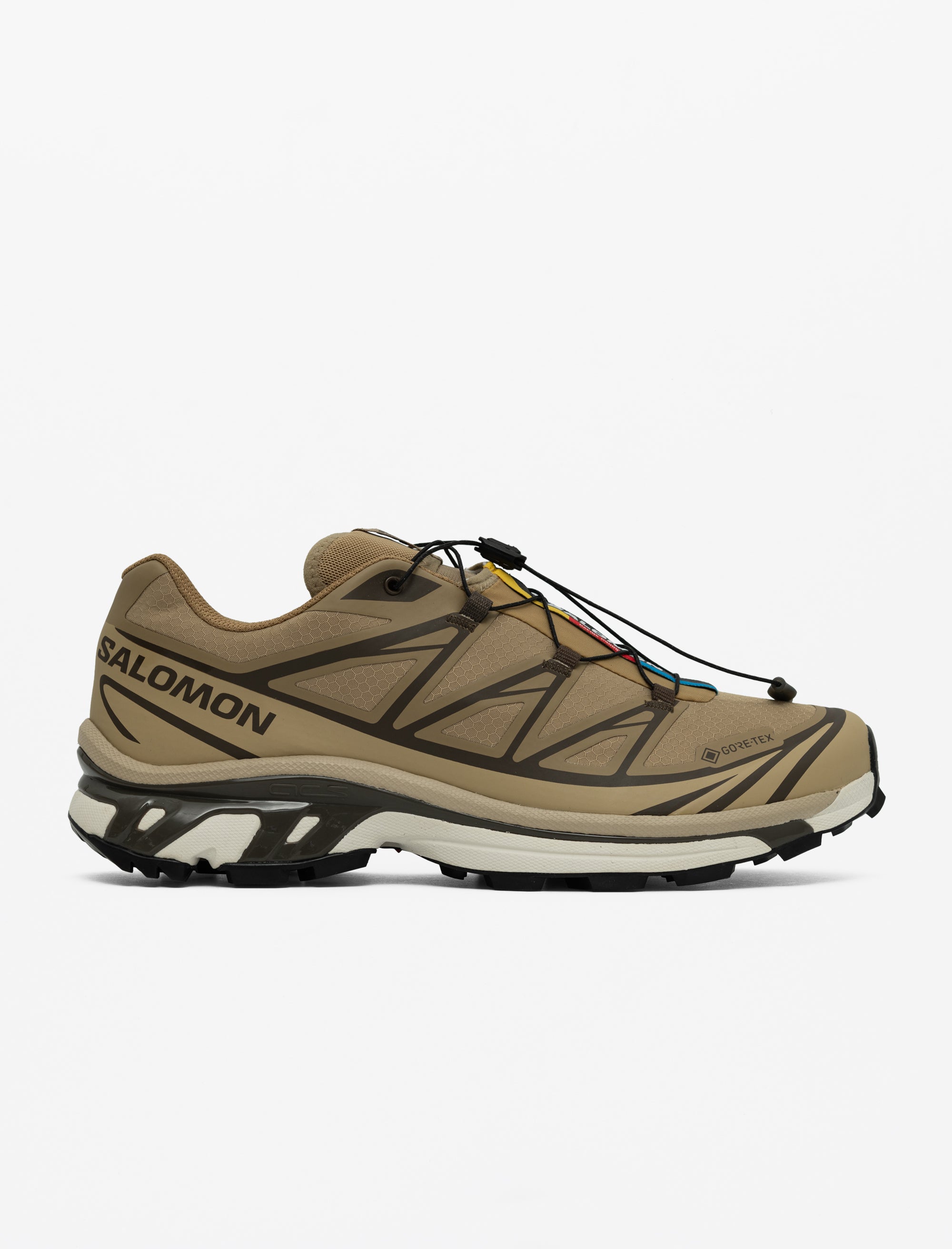 Tan hiking shoe with black accents on a white background